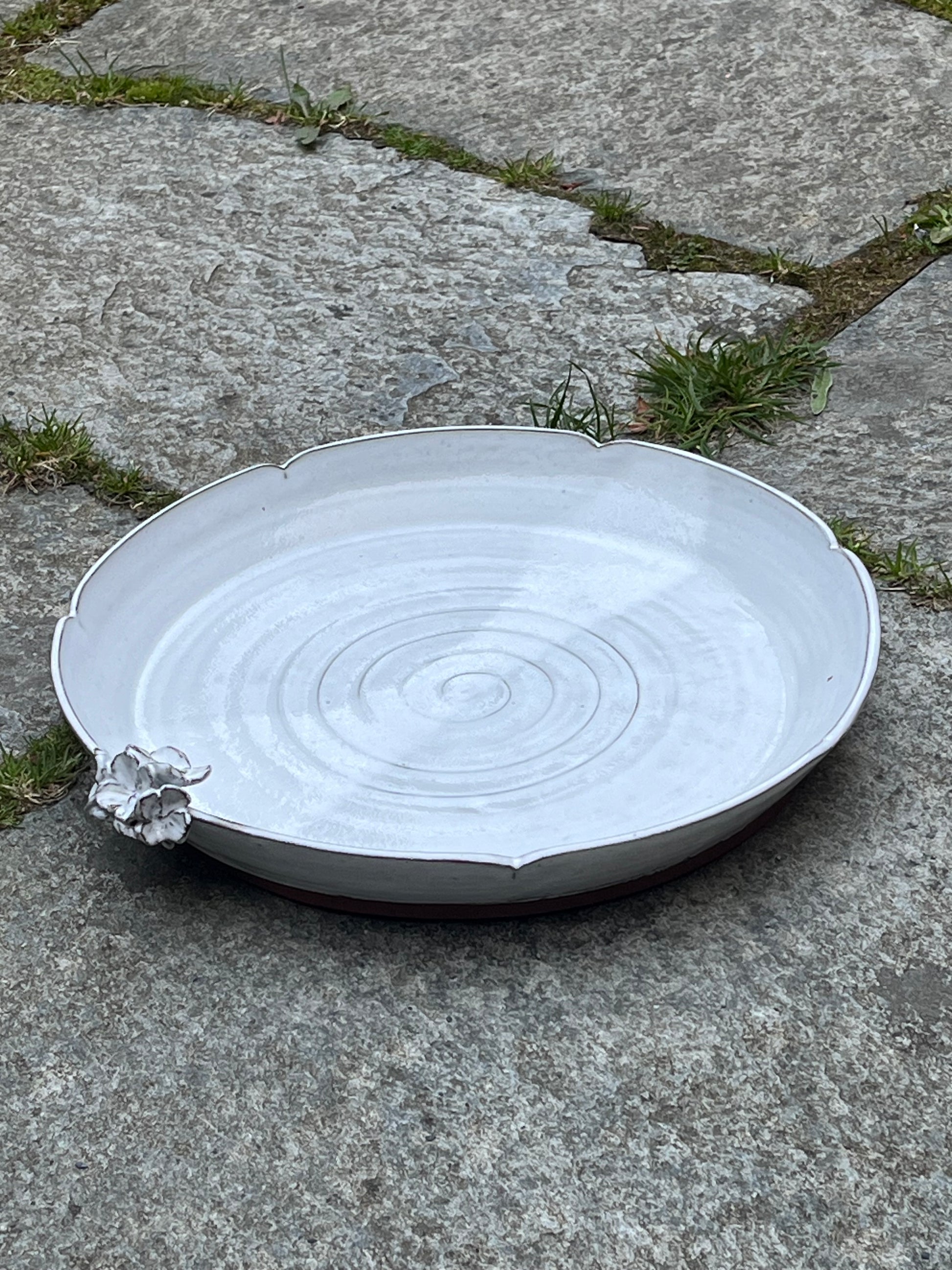 Stort fat med blomkant och blomma